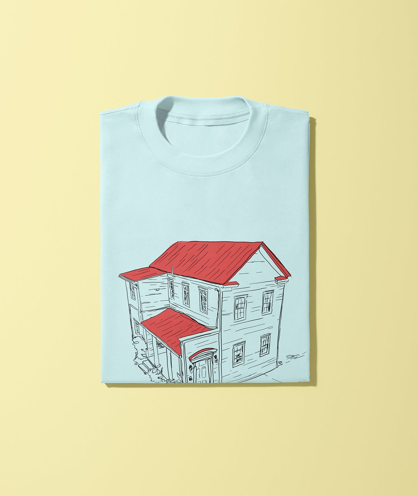 A light blue unisex short-sleeve t-shirt with a crew neck, displaying a graphic of a house with a red roof.
