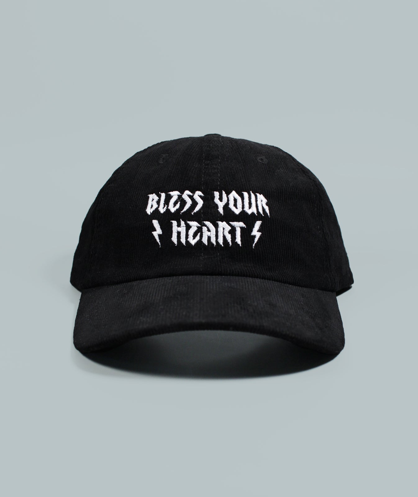 Black corduroy hat that says Bless Your Heart with lightning bolts