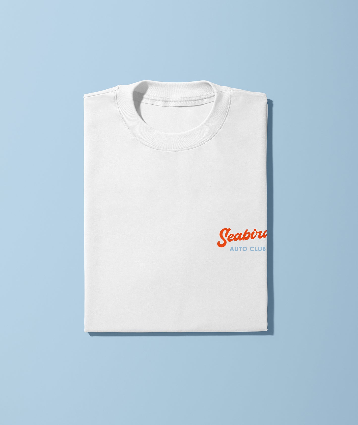 A white unisex short-sleeve crew neck t-shirt with a graphic print of a car and the text 'Seabird Auto Club' on the front.