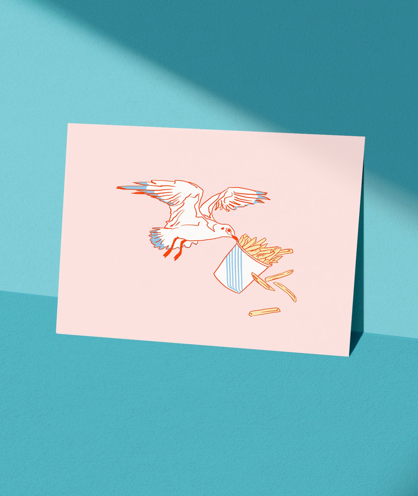 A fine art print featuring an illustration of a bird with fries on its back, placed on a surface with a shadow falling over part of the image.