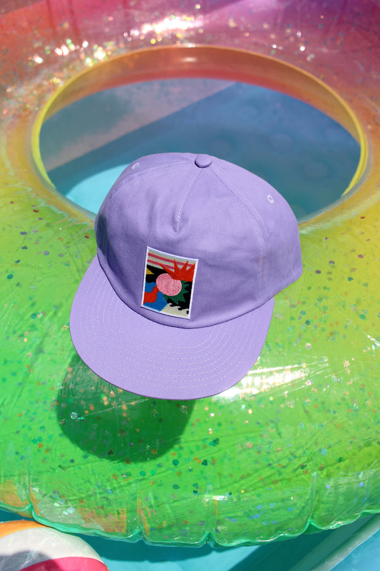Purple cap with a colorful patch on a pool float