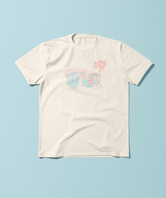 T-shirt with blue and pink beach cottage illustration on the front