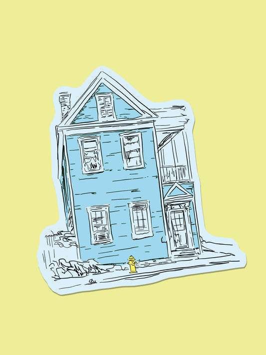A die-cut sticker featuring a hand-drawn illustration of a light blue house with black sketch lines and a small yellow fire hydrant, shown on a pale yellow background.