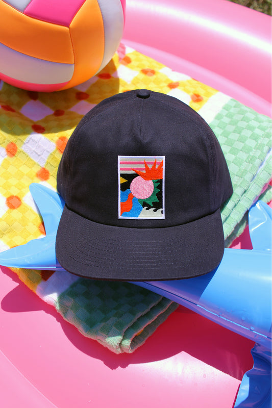 Navy cap with a colorful logo on a colorful inflatable pool toy