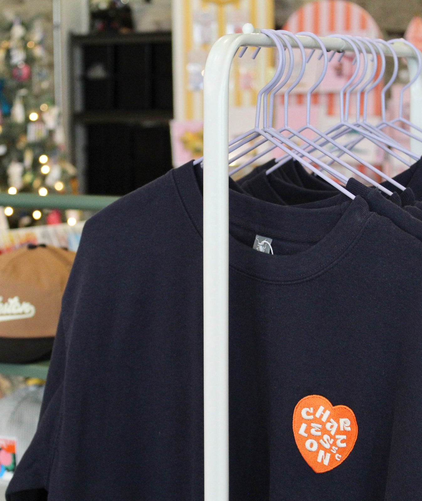 Charleston sweatshirt. Navy sweatshirt with a red heart-shaped Charleston  logo on a light gray background