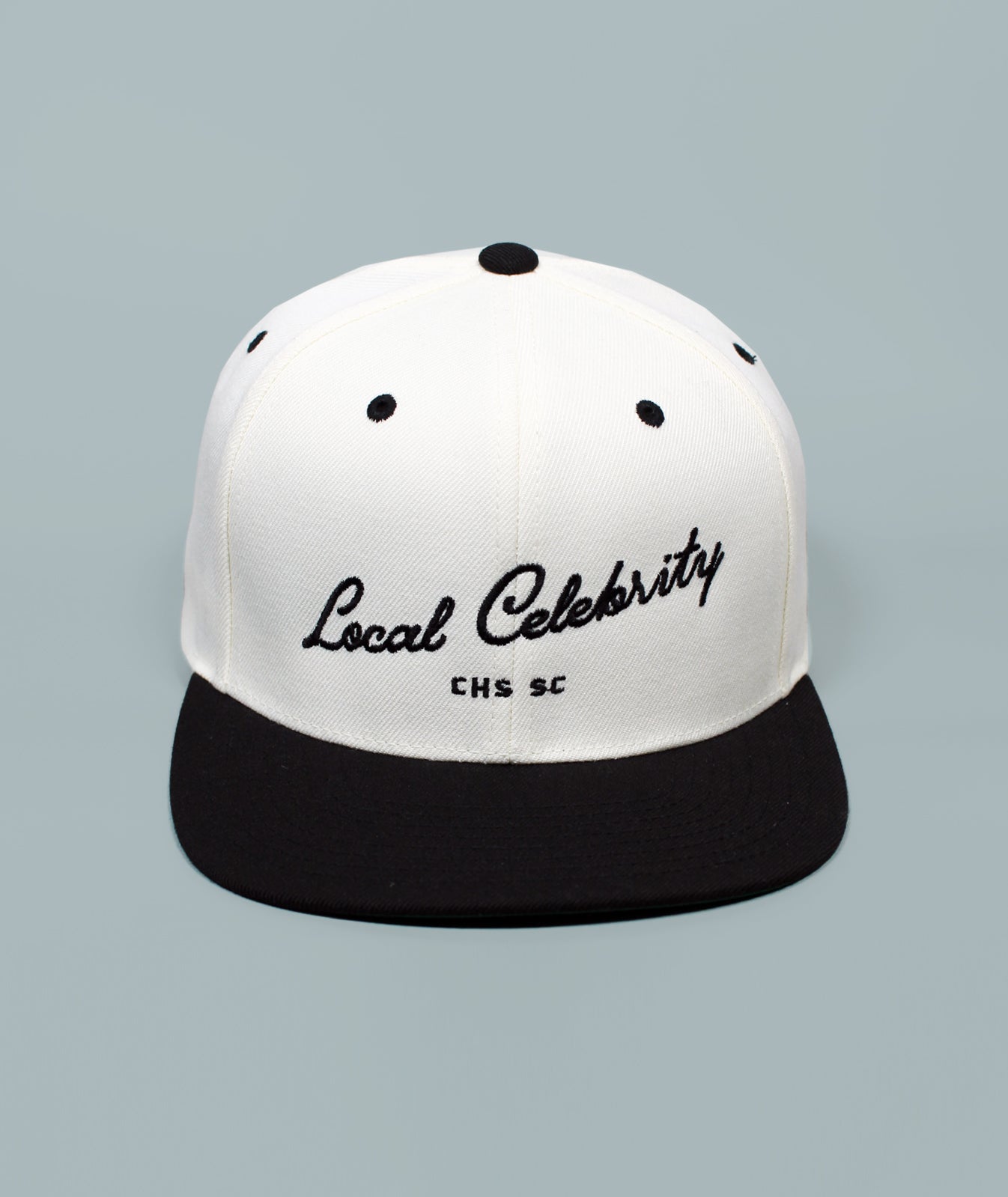 Charleston Hat. Local Celebrity Hat. White and black cap with 'Local Celebrity' text on a gray background
