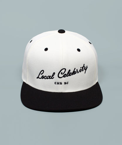 Charleston Hat. Local Celebrity Hat. White and black cap with 'Local Celebrity' text on a gray background