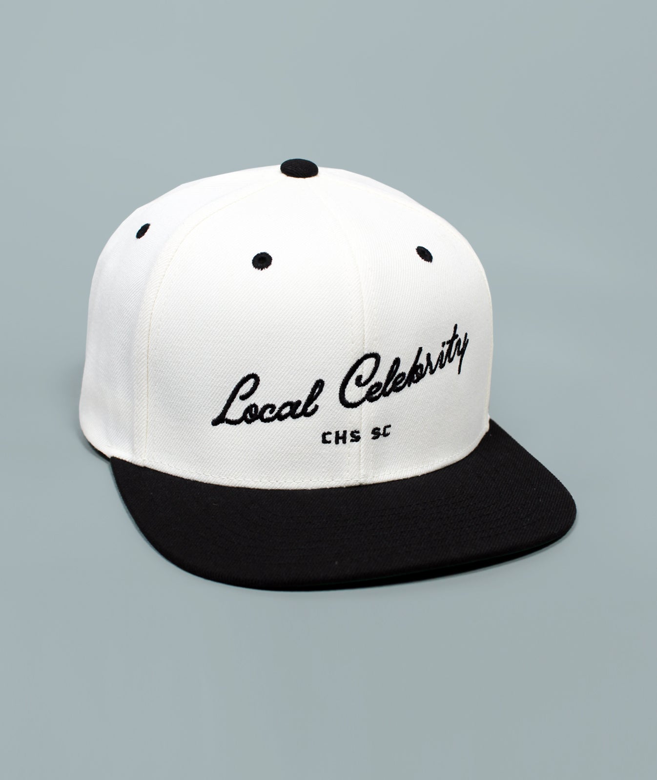 Charleston Hat. Local Celebrity Hat. White and black cap with 'Local Celebrity' text on a gray background