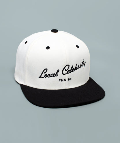 Charleston Hat. Local Celebrity Hat. White and black cap with 'Local Celebrity' text on a gray background