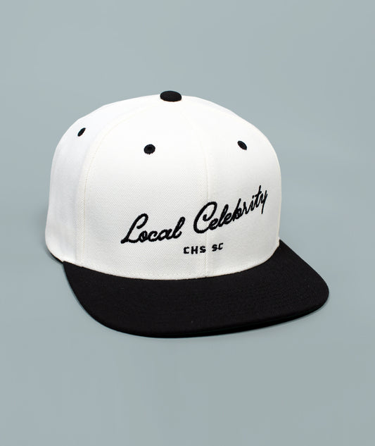 Charleston Hat. Local Celebrity Hat. White and black cap with 'Local Celebrity' text on a gray background