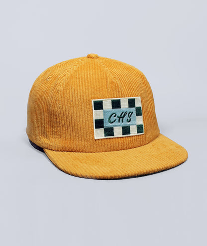 Charleston Hat. Yellow corduroy cap with a checkered patch on a light gray background