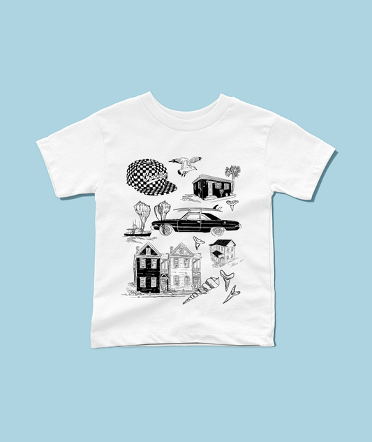 A white short-sleeve crewneck t-shirt featuring a black graphic print of various vintage illustrations, including houses, a car, a checkered hat, and birds, laid flat against a solid light blue background.